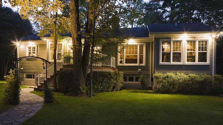 House at dusk with outdoor lights on