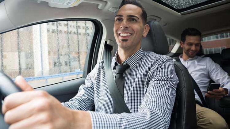 Person enjoying a safe ride from an Uber driver.