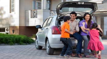 Family of four playing in their driveway.